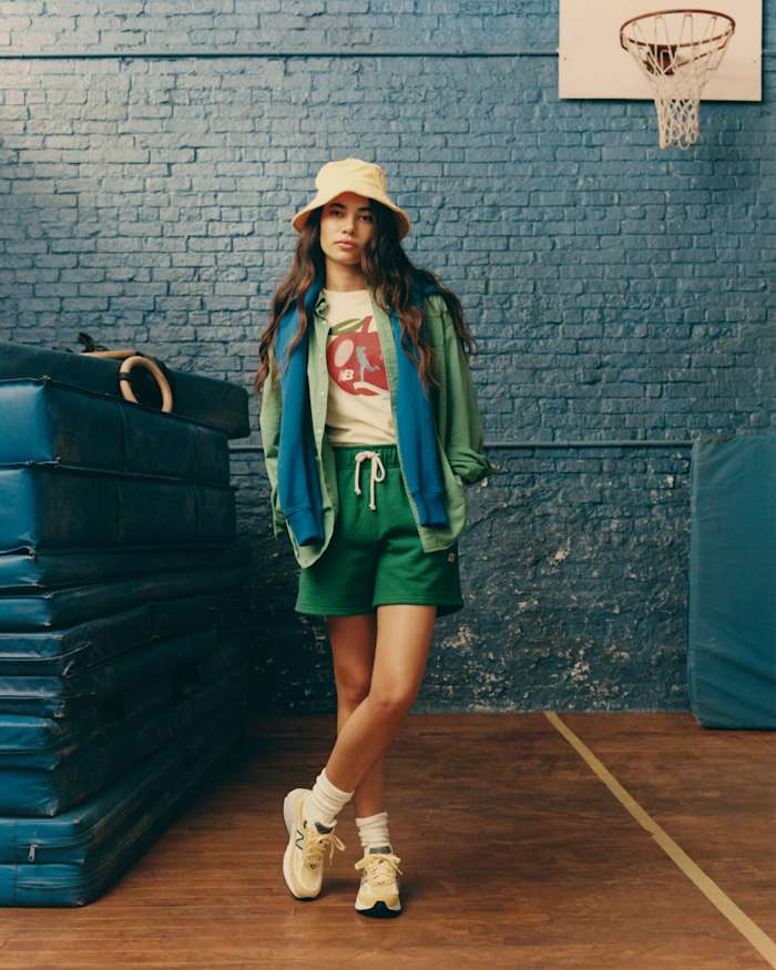 Female model poses in New Balance clothing.